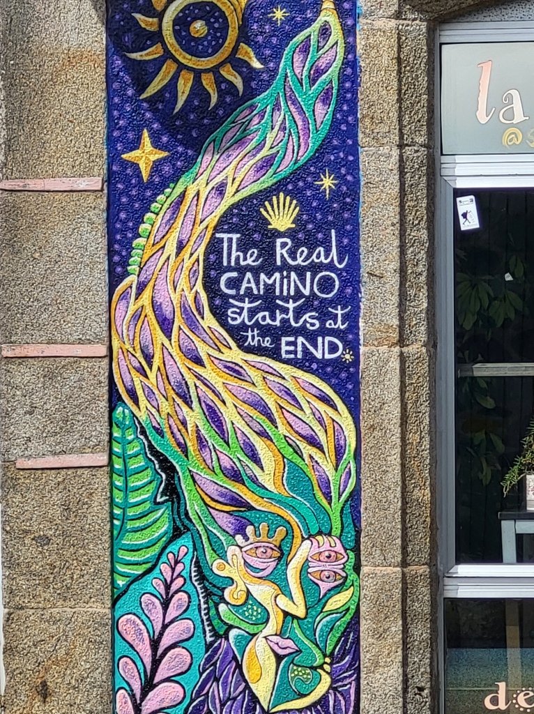 A mural painted on a wall in Finisterre claims "the real camino starts at the end."